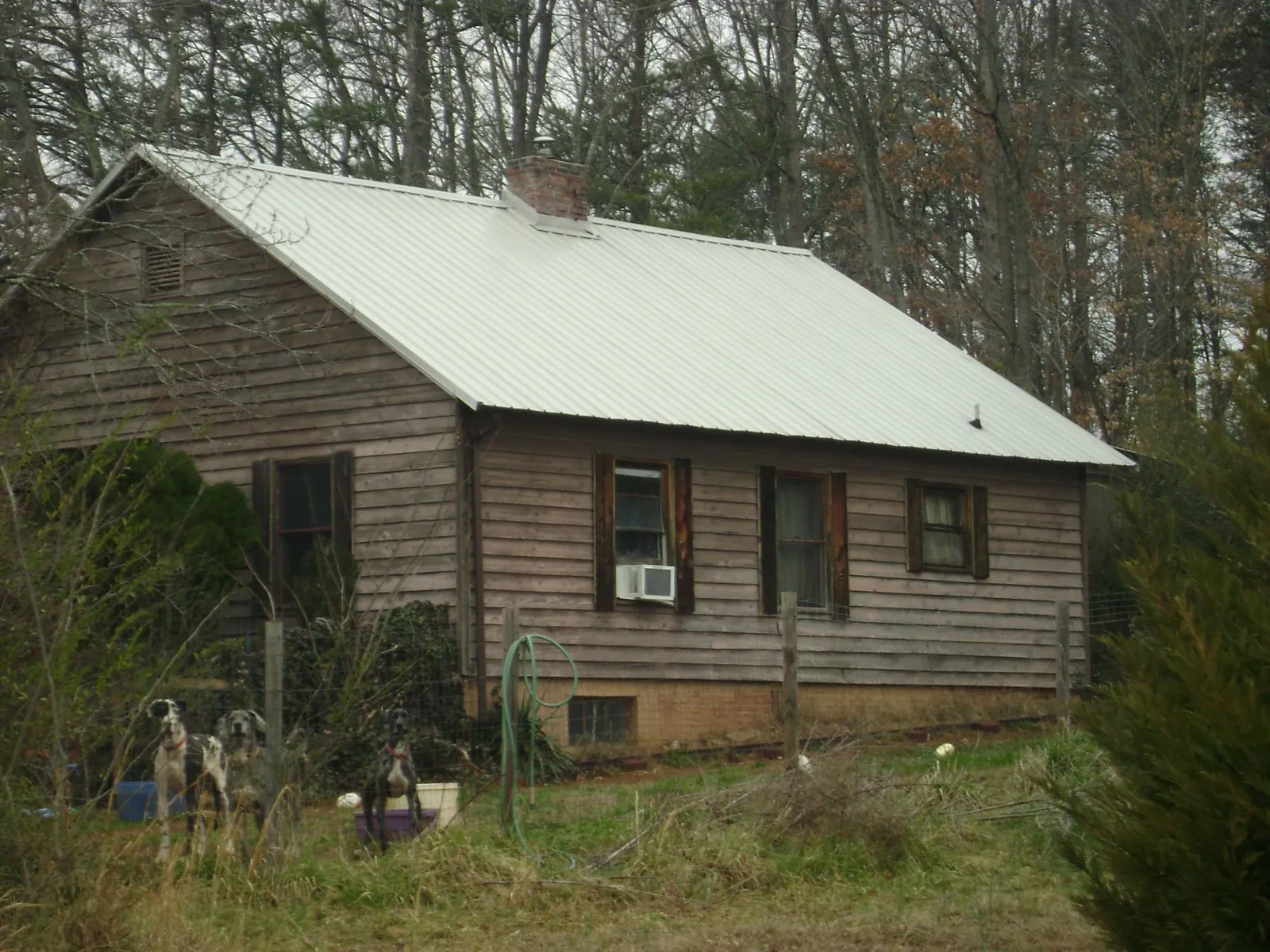 White metal roof on an old wood sided farmhouse, from a Metal Roof Installation job in Euclid